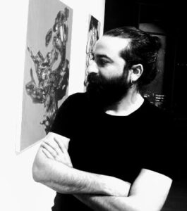 Portrait of a man at Kobani Festival art exhibition, showcasing contemporary Kurdish artwork.