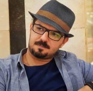 Colorful guy wearing a striped hat and glasses at Kobani Festival.