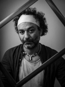 Reflections of a man at the Kobani Festival, showcasing cultural expression and artistry.